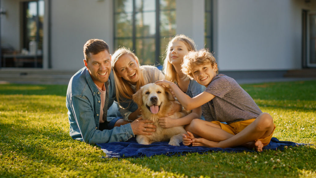 Family with Happy Golden Retriever Dog